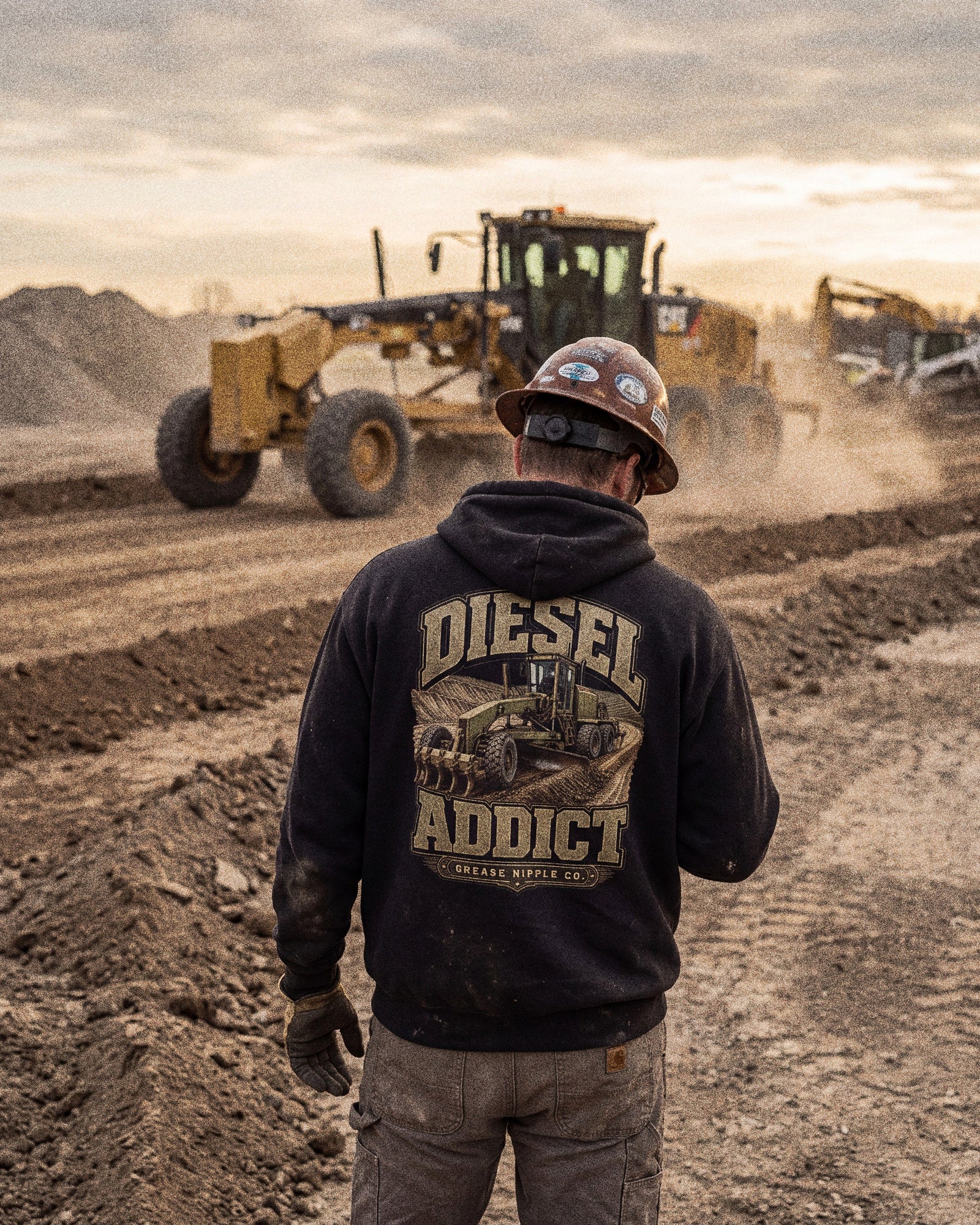 Diesel Addict motor grader hoodie worn by an operator on a quarry jobsite