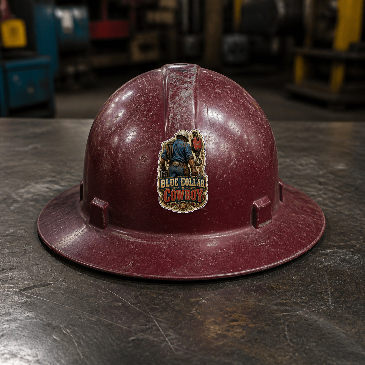 BLUE COLLAR COWBOY 3-inch vinyl sticker on a worn maroon full-brim hard hat