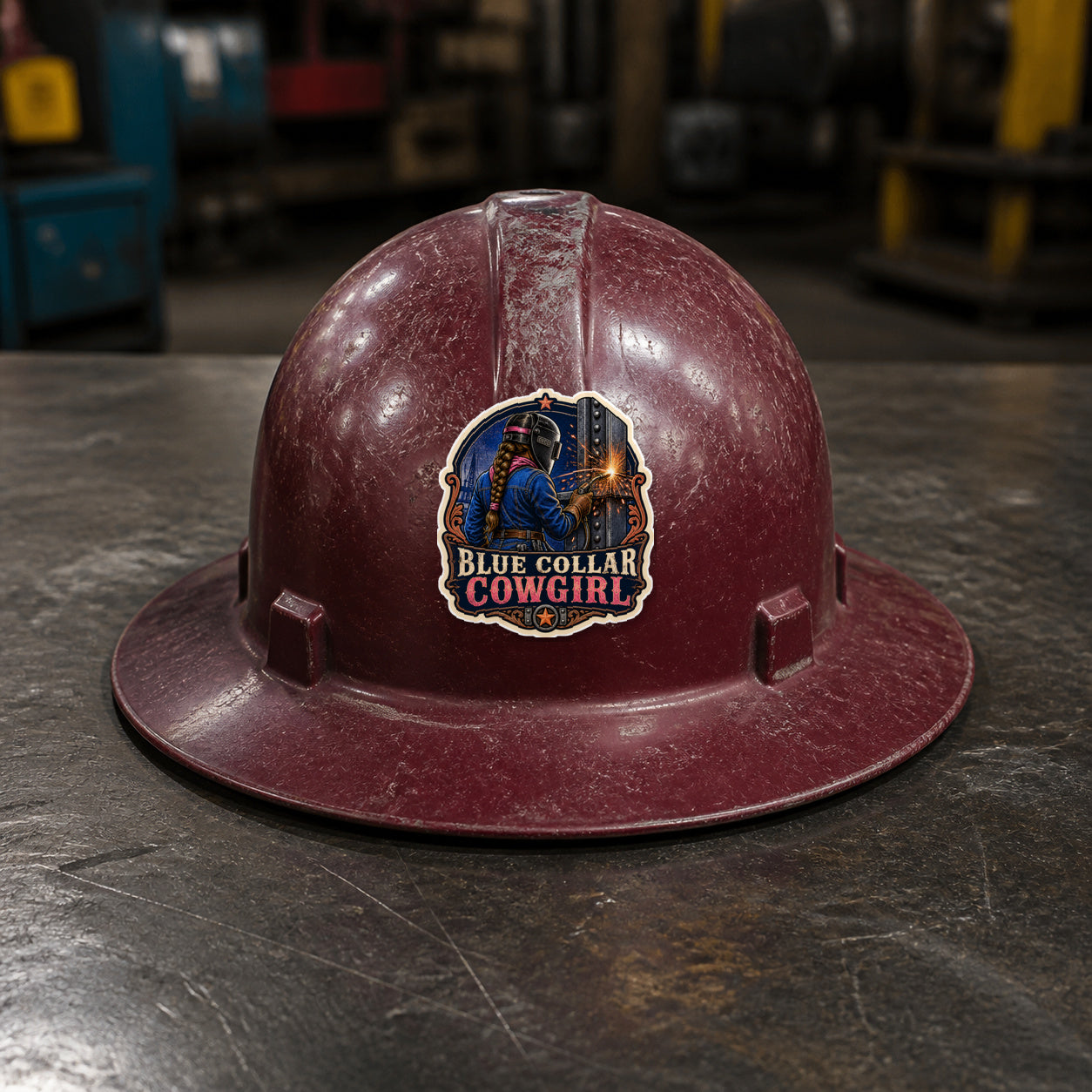 BLUE COLLAR COWGIRL 3-inch vinyl sticker on a worn maroon full-brim hard hat